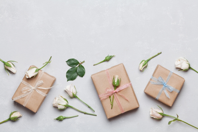 Present or gift decorated rose flowers. Holiday concept. Flat lay.